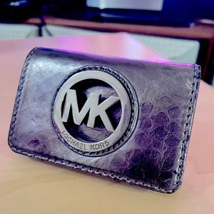 Micheal Kors Wallet in Metallic silver, in great shape with some wear.